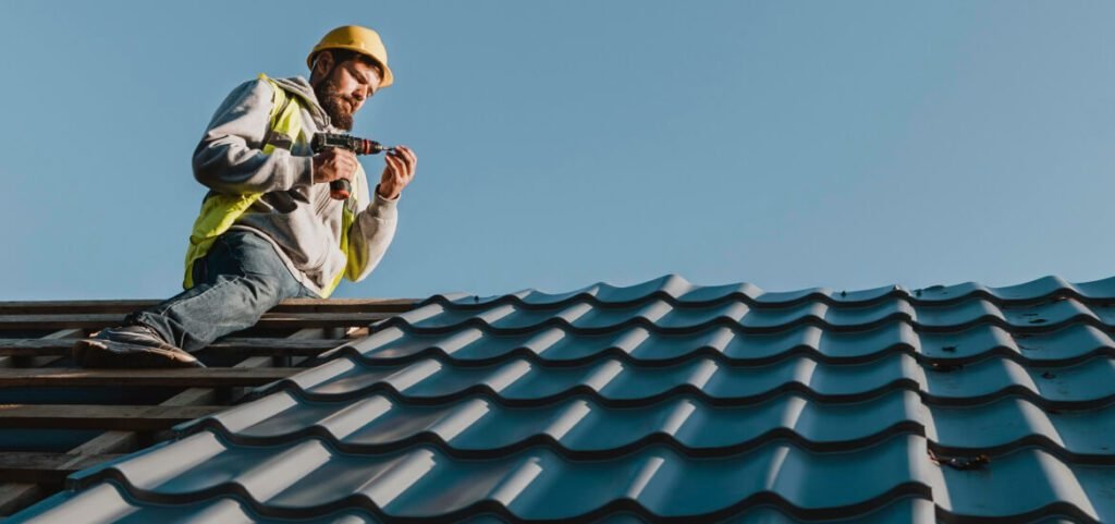 Man with drill on the roof