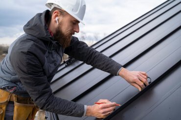 Man pulling socks on the roof