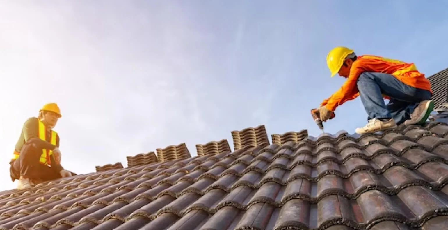 Two men working on the roof