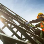 Man assembling the structure of a roof